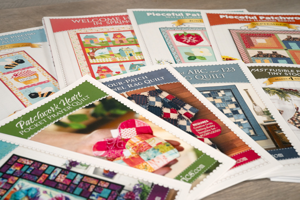 Colorful fabric pieces, butterflies, and a quilt design titled A Butterfly Quilt arranged artistically.