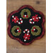 A decorative centerpiece featuring five Christmas wreaths and candy canes arranged on a black background with a scalloped edge. The wreaths are green with red bows and buttons, while the candy canes are red and white striped.