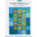 A quilt design featuring a grid of colorful squares, each displaying various emoji faces, including happy, sad, and playful expressions. The quilt is predominantly in shades of blue and green.