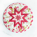 Red and white floral circular hot pad on a white background