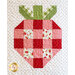 A quilted design of a strawberry, featuring red and pink checked patterns with floral squares. The green leaves are at the top, and the background is a white fabric with small black dots.