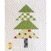 A quilted design of a Christmas tree made from various green fabrics arranged in triangular layers, with a patterned tree trunk at the bottom, all set against a white background with black polka dots.