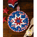 Blue folded star hot pad with tossed American Flags on a wood table