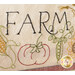 Embroidered textile featuring the word FARM in large letters with decorative elements including a pumpkin, peas in a pod, corn, and flowers surrounding the text.