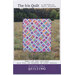 A quilt pattern titled The Iris Quilt by Erica Jackman, featuring a colorful design with a diagonal lattice pattern. The pattern is suitable for baby, lap, and twin sizes, and is compatible with jelly rolls, fat quarters, or scrap fabric. The background shows a grassy landscape.