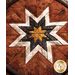 Brown, white, black and tan fabric layered to make a center star in the Folded Star Hot Pad