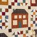 A close up of an orange house graphic on a quilt