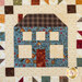 A close up of a blue house graphic on a quilt
