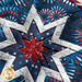 Round navy blue hot pad featuring a central star and firework motifs with red and white border.