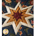 Dark blue, cream, ochre, and red folded star fabric design.