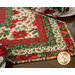 Christmas themed floral table topper on wood table.