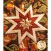 Round autumn themed floral hot pad with a central folded star design on wooden table.