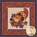 orange cornucopia filled with pumpkins, gourds, apples, and grapes appliquéd on cream background with dark orange floral borders