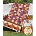 Table runner from purple, red, and orange patchwork squares with harvest pumpkin applique on ends.