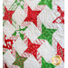 Christmas quilt featuring green and red stars on white background.