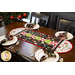 Christmas themed table runner featuring phrases, ornaments, and snowflakes, designed with rounded sides and central pinwheels.