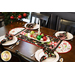 Christmas themed table runner featuring phrases, ornaments, and snowflakes, designed with rounded sides and central pinwheels.