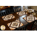 Coffee themed placemats made of brown, tan, and cream fabrics with coffee cups in the center surrounded by strips of fabric in a diamond shape.