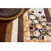 Table runner with central diamond design and angled strips the ends made of coffee themed fabrics in neutral colors.