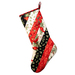 Hanging holiday stocking made from strips of Christmas themed fabric in red, black, and white.