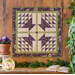 Wall hanging made with Geometric designs in purple and cream floral fabrics.