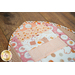 Fish shaped cat pet placemat made of strips of pink and cream cat themed fabrics.