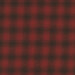 A textured pattern featuring red and black plaid.