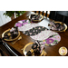 Braided twist being used as table runner on table set with plates and cloth napkins.