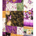 Quilt with patchwork design made of purple, yellow, teal, and black fabrics featuring florals, fish, and butterflies.