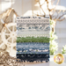 A stack of fabrics included in the Nantucket Summer fabric collection by Moda Fabrics