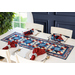 Red, white, and blue table runner made of patriotic fabric prints and geometric piecing.