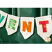 A decorative banner with colorful letters spelling VENT on white fabric flags, hanging against a dark green background.