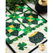 Cream table runner featuring green clovers, pots of gold, and geometric designs.