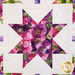 A quilt with geometric square and triangle designs made of multicolor fabrics on white.