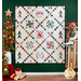 White quilt with lattice made of small squares and holiday motifs in between.