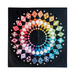 Quilt with circular geometric patterns arranged in a multicolored rainbow gradient on black background.