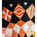 Geometric patterns in orange on black fabric.