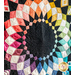 Quilt with circular geometric patterns arranged in a multicolored rainbow gradient on black background.