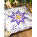 Square hot pad with central folded star design made of purple and white floral printed fabrics.