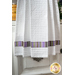 White waffle textured towel with striped banding.