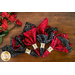 Reversible cloth napkins featuring packed red roses on one side and white cursive writing on black on the other.