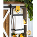 Hanging towel made of white bee themed fabrics with black and yellow accents.