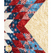 A colorful quilt featuring red, white, and blue patterns with stars and stripes, including a golden section.