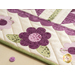 Table runner with geometric triangle and scallop design with appliqué flowers on the ends.