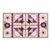 Table runner with geometric triangle and scallop design with appliqué flowers on the ends.