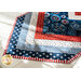 Table runner with central diamond design and angled strips at the ends made of patriotic printed fabrics.