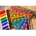 Colorful spools of thread arranged with colorful acrylic rulers that say 