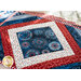 Placemats made of strips of patriotic printed red, white, and blue strips of fabric in a diamond design.