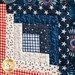 Quilt square made up of strips of red, white, and blue patriotic fabric prints.