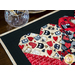 Table runner with interlocking hearts design made of illustrated cat printed fabrics and black border.